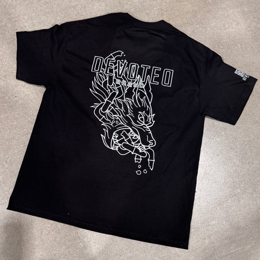 Devoted Brand Breakthrough Tee flat lay showing bold back design with shattered chain and wolf graphic and clean line art on black heavyweight cotton.