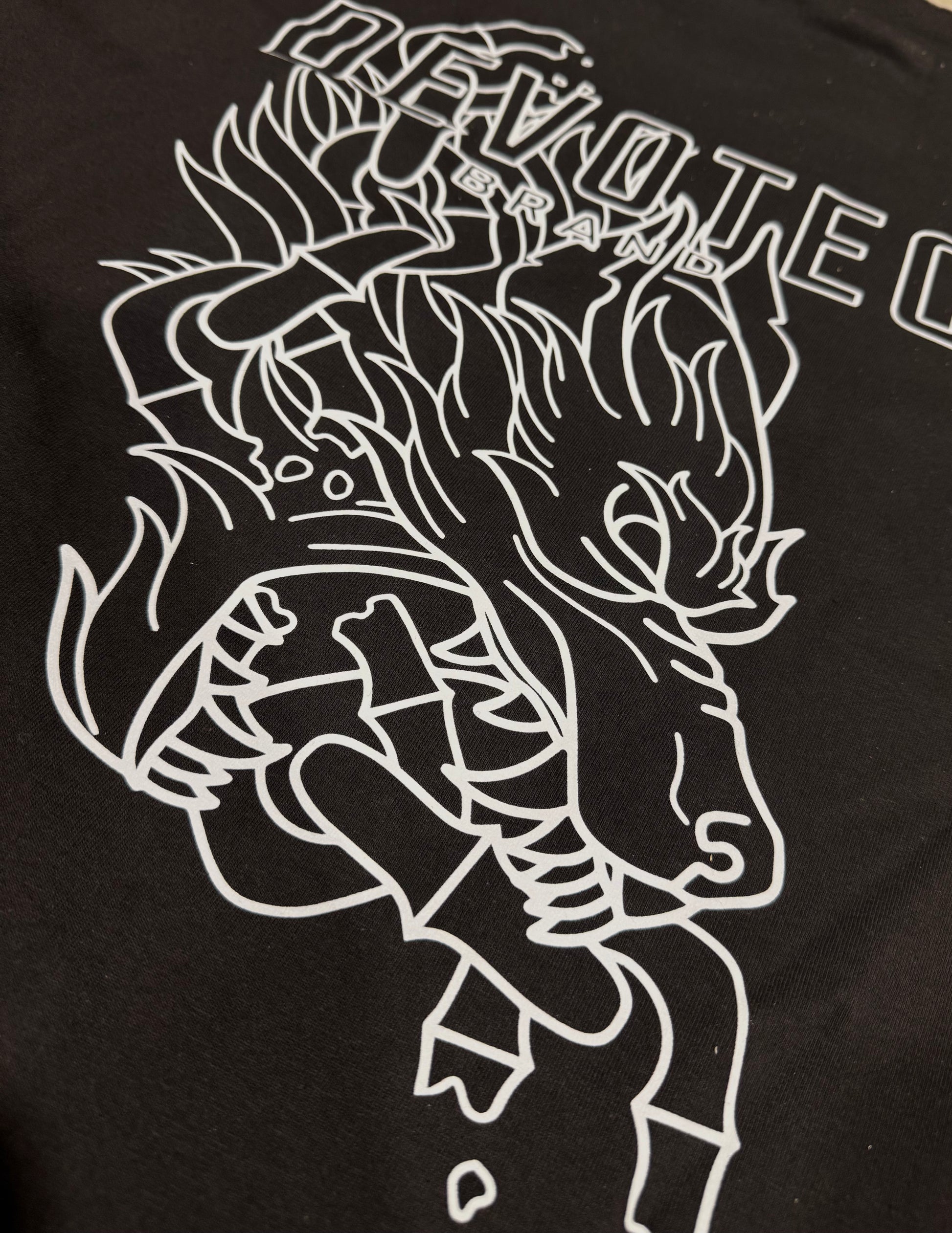 Close-up of Breakthrough Tee back design showing detailed white line art of fierce wolf illustration and Devoted Brand text