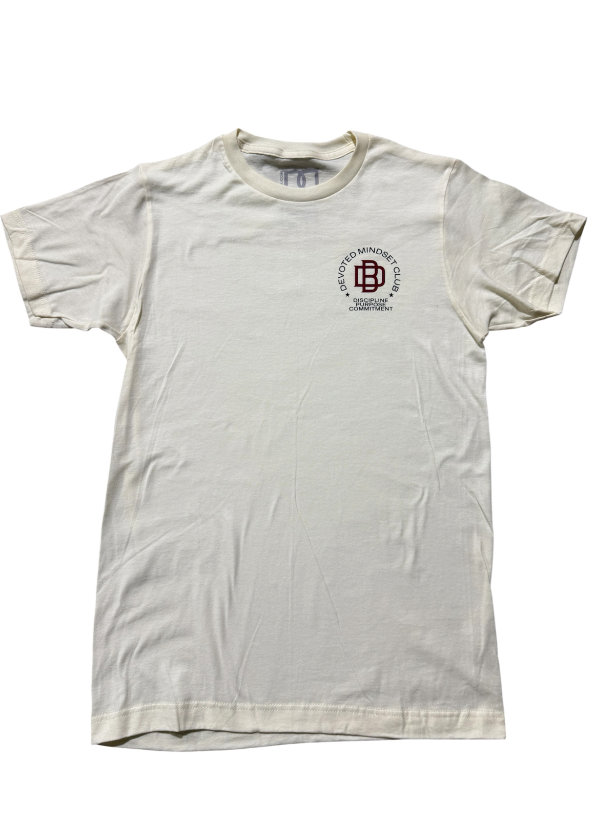 DMC Uniform 005 Purpose Over Hype Tee in Legacy vintage cream, front view with DMC crest
